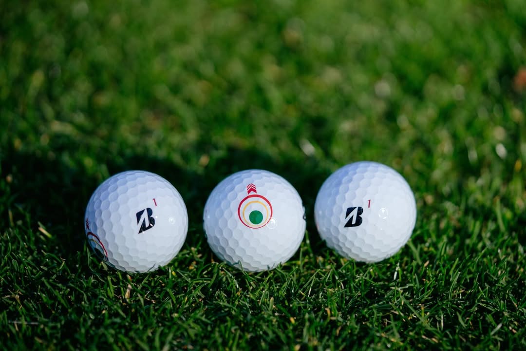 Golf balls with visible alignment markings on a putting green